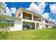Spacious backyard featuring a covered patio, ceiling fans, and well-maintained green grass at 13809 Abberwick Dr, Orlando, FL 32832