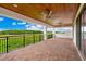 This large balcony offers stunning views of the green landscape with a beautiful wood ceiling at 13809 Abberwick Dr, Orlando, FL 32832