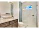 Modern bathroom with granite countertop, under mount sink, glass shower and tiled walls at 13809 Abberwick Dr, Orlando, FL 32832