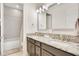 Bathroom with double sinks, granite countertops, and a shower-tub combination at 13809 Abberwick Dr, Orlando, FL 32832
