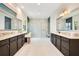 This bathroom boasts dual vanities with granite countertops and a spacious glass-enclosed shower for a spa-like experience at 13809 Abberwick Dr, Orlando, FL 32832