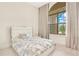 This is a charming bedroom with a statement window, allowing plenty of natural light into the space at 13809 Abberwick Dr, Orlando, FL 32832