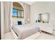 Well-lit bedroom with a large window, neutral tones and stylish furniture at 13809 Abberwick Dr, Orlando, FL 32832