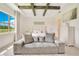 This is a luxurious bedroom featuring a tray ceiling, a cozy seating area, and an abundance of natural light at 13809 Abberwick Dr, Orlando, FL 32832