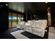 This is a home theater with tiered seating, and a large window for viewing serene landscapes at 13809 Abberwick Dr, Orlando, FL 32832