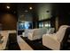 Enjoy movie nights in this home theater with white leather reclining chairs and a convenient wet bar at 13809 Abberwick Dr, Orlando, FL 32832