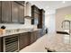 Sleek kitchen featuring dark wood cabinetry, granite countertops, and built-in stainless steel appliances at 13809 Abberwick Dr, Orlando, FL 32832