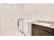 This is a functional laundry room offering ample space for laundry appliances and a convenient sink area at 13809 Abberwick Dr, Orlando, FL 32832