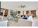 Open-concept living room featuring tile flooring, a ceiling fan, and staircase at 13809 Abberwick Dr, Orlando, FL 32832