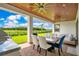 The covered patio features a wood ceiling, a ceiling fan, outdoor kitchen and an outdoor dining area at 13809 Abberwick Dr, Orlando, FL 32832