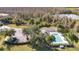 Aerial view of a community pool surrounded by palm trees and lush landscaping, with parking and a nearby pond at 13809 Abberwick Dr, Orlando, FL 32832