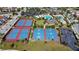 Aerial view showcasing community tennis and basketball courts with clubhouse and pool in background at 13809 Abberwick Dr, Orlando, FL 32832