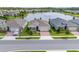 A serene lakefront setting enhances this new home's appeal with well-manicured lawns in a friendly neighborhood at 17795 Blazing Star Cir, Clermont, FL 34714