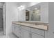 Bathroom with granite counters, double sinks, and access to walk-in closet and glass enclosed shower at 17795 Blazing Star Cir, Clermont, FL 34714