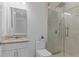 Modern bathroom featuring granite counters, glass shower with tiled walls, and stylish fixtures at 17795 Blazing Star Cir, Clermont, FL 34714