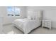 Serene bedroom with large window, shutters, lake view, and plush bedding at 17795 Blazing Star Cir, Clermont, FL 34714