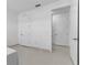 Bedroom featuring white doors and tiled floors leading into the hallway at 17795 Blazing Star Cir, Clermont, FL 34714