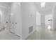 Bright foyer with glossy tile, showcasing a door to the bathroom and dining area in the background at 17795 Blazing Star Cir, Clermont, FL 34714