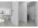 View of the kitchen and laundry room from the hallway, showcasing the home's open layout and modern amenities at 17795 Blazing Star Cir, Clermont, FL 34714