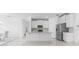 Modern kitchen with stainless steel appliances, white cabinets, and a granite countertop island, open to living spaces at 17795 Blazing Star Cir, Clermont, FL 34714