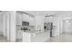 Modern kitchen with stainless steel appliances, white cabinets, and a granite countertop island at 17795 Blazing Star Cir, Clermont, FL 34714