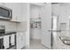 View of the kitchen with stainless steel appliances and a pantry behind an open door at 17795 Blazing Star Cir, Clermont, FL 34714