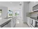 Modern kitchen featuring stainless steel appliances, granite countertops, and a view to the dining area at 17795 Blazing Star Cir, Clermont, FL 34714