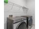 Modern laundry room featuring a Samsung washer and dryer, and wire shelving for optimal storage at 17795 Blazing Star Cir, Clermont, FL 34714