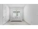 Bright living room featuring white walls, large window, and sleek sofa at 17795 Blazing Star Cir, Clermont, FL 34714