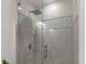 Glass enclosed shower with tiled walls and rain style shower head at 17795 Blazing Star Cir, Clermont, FL 34714