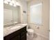 Bathroom features a granite countertop, modern fixtures, and a bright window providing natural light at 1876 Summer Dr, Davenport, FL 33897