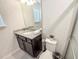 Bathroom with a granite countertop, modern fixtures, and a window for natural light at 1876 Summer Dr, Davenport, FL 33897