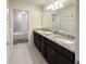 Bathroom featuring double sinks, granite countertops, a shower and bath tub at 1876 Summer Dr, Davenport, FL 33897
