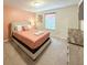 Cozy bedroom with a double bed, soft lighting, and neutral decor, creating a calming and comfortable atmosphere at 1876 Summer Dr, Davenport, FL 33897