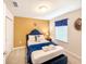 Cozy bedroom with a queen-sized bed, blue accents, and soft lighting at 1876 Summer Dr, Davenport, FL 33897