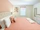 Comfortable bedroom featuring a neutral color palette, tufted headboard, and soft textures for a relaxing retreat at 1876 Summer Dr, Davenport, FL 33897
