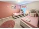 Adorable pink-themed bedroom with two twin beds and princess decor at 1876 Summer Dr, Davenport, FL 33897