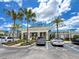 Inviting clubhouse with well-kept landscaping, ample parking, and covered entryway with stone accents at 1876 Summer Dr, Davenport, FL 33897