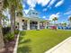Exterior shot of the clubhouse featuring an open-air social area with a view of the pool and surrounding landscape at 1876 Summer Dr, Davenport, FL 33897