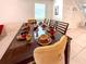 Elegant dining room featuring a large table set for a meal, decorative plates and cups, and sophisticated chairs at 1876 Summer Dr, Davenport, FL 33897