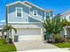 Charming two-story home with blue siding, stone accents, and a paver driveway at 1876 Summer Dr, Davenport, FL 33897