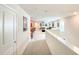 Hallway leads to a bonus room featuring a game table and theater chairs, perfect for entertaining at 1876 Summer Dr, Davenport, FL 33897