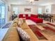 Spacious living room with a dining area, bright sofas, and an open layout at 1876 Summer Dr, Davenport, FL 33897