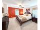 Spacious main bedroom with carpet, ceiling fan, large bed, and warm accents, creating a cozy and inviting retreat at 1876 Summer Dr, Davenport, FL 33897