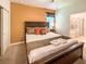 Comfortable bedroom with a well-decorated queen bed, warm lighting, and an en-suite bathroom at 1876 Summer Dr, Davenport, FL 33897