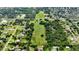 An aerial view reveals a large property amid a mix of trees and homes in a sprawling neighborhood at 1886 Pleasant Hill Rd, Kissimmee, FL 34746