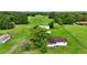 An aerial view of a property with mature trees and a quaint house nestled in a lush green landscape at 1886 Pleasant Hill Rd, Kissimmee, FL 34746