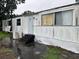 Exterior of a white mobile home with a weathered appearance at 1886 Pleasant Hill Rd, Kissimmee, FL 34746