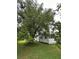 Exterior of weathered white house with large tree in front yard at 1886 Pleasant Hill Rd, Kissimmee, FL 34746