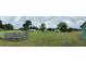 Large, partially fenced lot with scattered sheds and a mobile home needing work at 1886 Pleasant Hill Rd, Kissimmee, FL 34746